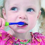 child brushes teeth